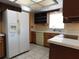 Kitchen showcasing tile floors, a white refrigerator, and wood cabinets at 130 Krider Rd, Sanford, FL 32773