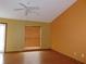 The living room has a ceiling fan, wood floor, and a large window at 130 Krider Rd, Sanford, FL 32773