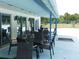 Outdoor patio with tables and chairs, adjacent to the pool, provide a comfortable space for dining and socializing at 130 Krider Rd, Sanford, FL 32773