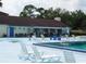 Community pool area with plenty of chairs and an attached recreation room at 130 Krider Rd, Sanford, FL 32773