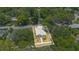 Aerial view of the home with its surrounding lot and nearby greenery in a residential area at 1371 Lake Dr, Casselberry, FL 32707