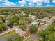 Neighborhood aerial view showcasing lush landscaping, mature trees, residential homes and roadways at 1371 Lake Dr, Casselberry, FL 32707