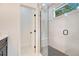 Modern bathroom featuring walk-in shower with black hardware, and a small window for natural light at 1371 Lake Dr, Casselberry, FL 32707