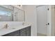 Modern bathroom featuring dual sinks with gold fixtures and a large mirror at 1371 Lake Dr, Casselberry, FL 32707