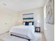 Cozy bedroom features a plush rug, calming wall art, and natural light from window at 1371 Lake Dr, Casselberry, FL 32707