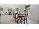 Bright dining area features modern table with seating and is open to living area with large window at 1371 Lake Dr, Casselberry, FL 32707