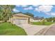 Well-manicured lawn and inviting driveway leading to the attached two-car garage of this single-story home at 1371 Lake Dr, Casselberry, FL 32707
