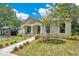 Beautifully landscaped front yard with a paver walkway leading to the welcoming front porch at 1371 Lake Dr, Casselberry, FL 32707