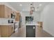 Well-lit kitchen with a center island, wooden cabinets, stainless steel appliances, and sleek countertops at 1371 Lake Dr, Casselberry, FL 32707
