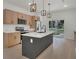 Modern kitchen features a center island, stainless steel appliances, bright white countertops and custom cabinets at 1371 Lake Dr, Casselberry, FL 32707