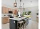 Open kitchen with island seating and a view to the backyard through sliding glass doors at 1371 Lake Dr, Casselberry, FL 32707