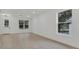 Bright, airy living room features new flooring, and fresh white walls with natural light at 1371 Lake Dr, Casselberry, FL 32707