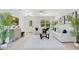 Bright living room featuring white sofas, modern decor, and large windows at 1371 Lake Dr, Casselberry, FL 32707