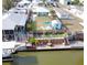 Aerial view of waterfront home with dock and fenced yard and outdoor seating at 139 Randle Ave, Oak Hill, FL 32759