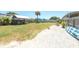 Spacious backyard with a mix of grass and shell, featuring a shed and covered patio at 139 Randle Ave, Oak Hill, FL 32759