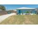 Backyard with a well-maintained lawn, gravel area, and tidy fencing at 139 Randle Ave, Oak Hill, FL 32759