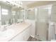Well-lit bathroom with a glass-enclosed shower, sleek vanity, and a modern design at 139 Randle Ave, Oak Hill, FL 32759