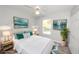 Brightly lit staged bedroom featuring a comfortable bed, stylish decor, and plenty of natural light at 139 Randle Ave, Oak Hill, FL 32759