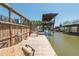 Waterfront dock with stairs, a cooler, and beautiful canal views at 139 Randle Ave, Oak Hill, FL 32759