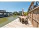 Waterfront dock with outdoor dining area, perfect for enjoying waterfront views and entertaining at 139 Randle Ave, Oak Hill, FL 32759