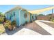 Charming waterfront cottage with shade covering, a yellow door, potted plants, and a welcoming facade at 139 Randle Ave, Oak Hill, FL 32759