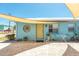 Quaint exterior with vibrant blue accents, yellow door, and cozy seating area at 139 Randle Ave, Oak Hill, FL 32759