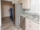 Functional kitchen space including stainless steel appliances and a nearby laundry area at 139 Randle Ave, Oak Hill, FL 32759