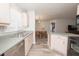 Bright kitchen featuring stainless steel appliances, light wood cabinets, and a view into the dining area at 139 Randle Ave, Oak Hill, FL 32759