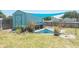 Outdoor shed with sun sail in backyard including plants and outdoor workbench at 139 Randle Ave, Oak Hill, FL 32759