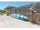 Side yard featuring neutral rocks with modern fence, complete with a stylish kayak at 139 Randle Ave, Oak Hill, FL 32759