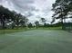 An outdoor basketball court with green surfacing and basketball hoop is ready for some action at 14025 Fairway Island Dr # 335, Orlando, FL 32837