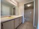 Well-lit bathroom featuring a large vanity with adjacent bathroom and a tub-shower combo for convenience at 14025 Fairway Island Dr # 335, Orlando, FL 32837