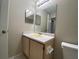 Simple bathroom features a large mirror and a functional vanity, ready for daily use at 14025 Fairway Island Dr # 335, Orlando, FL 32837