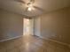 Clean bedroom featuring a ceiling fan, closet space, and a view into an adjoining bathroom at 14025 Fairway Island Dr # 335, Orlando, FL 32837