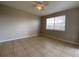 Sunlit bedroom offers a spacious area with a large window, providing a bright and airy feel at 14025 Fairway Island Dr # 335, Orlando, FL 32837
