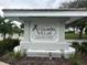 The Audubon Villas at Hunter's Creek community sign is surrounded by mature plants and landscaping at 14025 Fairway Island Dr # 335, Orlando, FL 32837
