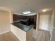 Kitchen with stainless steel sink, dark cabinets, and updated appliances at 14025 Fairway Island Dr # 335, Orlando, FL 32837