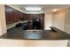 Well-lit kitchen features modern appliances, dark cabinetry and breakfast bar at 14025 Fairway Island Dr # 335, Orlando, FL 32837