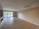 Spacious living room with tile flooring and sliding glass doors leading to a balcony at 14025 Fairway Island Dr # 335, Orlando, FL 32837