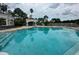 Community pool with inviting turquoise water and comfortable seating area at 14025 Fairway Island Dr # 335, Orlando, FL 32837