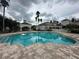 Community pool with cool blue water, poolside pavilion, and mature trees at 14025 Fairway Island Dr # 335, Orlando, FL 32837