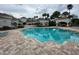Community pool with plenty of poolside seating and lush landscaping at 14025 Fairway Island Dr # 335, Orlando, FL 32837