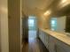 Bathroom with double vanity, tiled floors, and large mirror at 1407 Mount Royal Dr, St Cloud, FL 34771