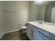 Neutral bathroom features wood-look tile floor, single sink vanity, and a toilet at 1407 Mount Royal Dr, St Cloud, FL 34771