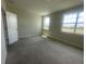 Bedroom features neutral carpet, natural light, and two large windows at 1407 Mount Royal Dr, St Cloud, FL 34771