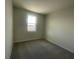 Bedroom with neutral carpet and a bright window at 1407 Mount Royal Dr, St Cloud, FL 34771