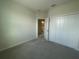 Bedroom featuring carpet, double door closet and view to bath at 1407 Mount Royal Dr, St Cloud, FL 34771