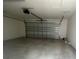 Spacious garage featuring an automatic door, offering ample space for vehicles and storage at 1407 Mount Royal Dr, St Cloud, FL 34771