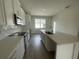 Stylish kitchen featuring white cabinets and stainless steel appliances at 1407 Mount Royal Dr, St Cloud, FL 34771