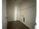 Small laundry room with wood-look floors at 1407 Mount Royal Dr, St Cloud, FL 34771